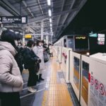 a group of people waiting at a train station