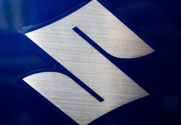 Close-up of a SUZUKI logo on a motorbike