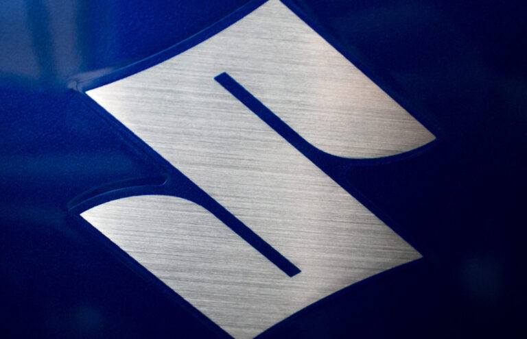 Close-up of a SUZUKI logo on a motorbike
